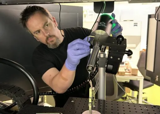 A scientist aligns a wide-angle Cryostream to a botanical sample, preparing it for micro-CT analysis.