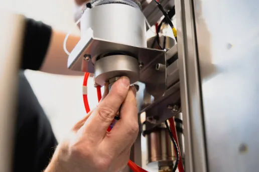 An service engineer performs maintenance on a Cryostream.