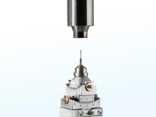 Close-up of a Cryostream nozzle precisely aligned above a MiTeGen sample pin and xHuber goniometer.
